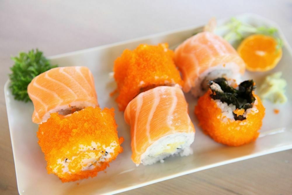 Salmon maki sushi on white plate